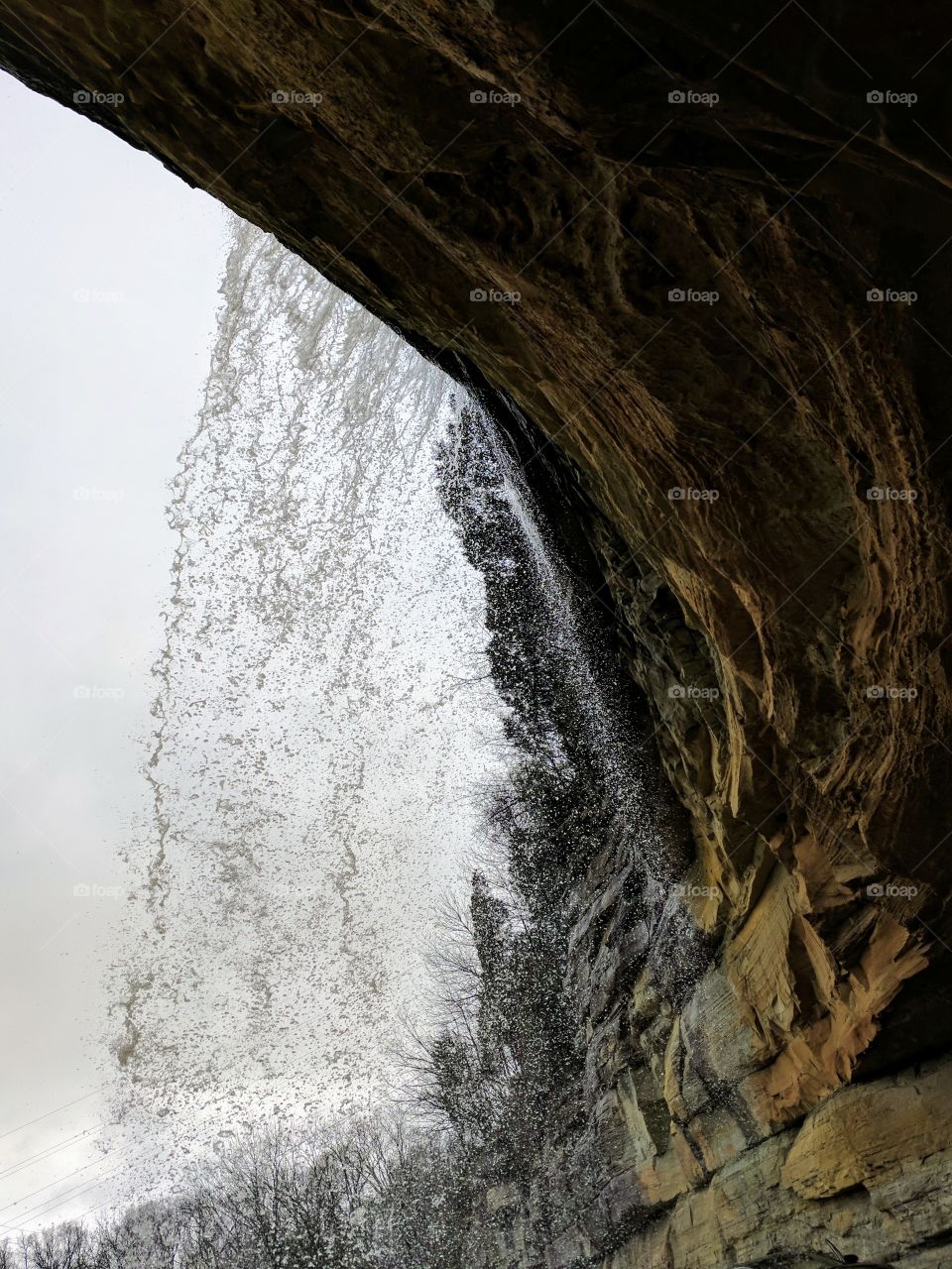 behind the waterfall