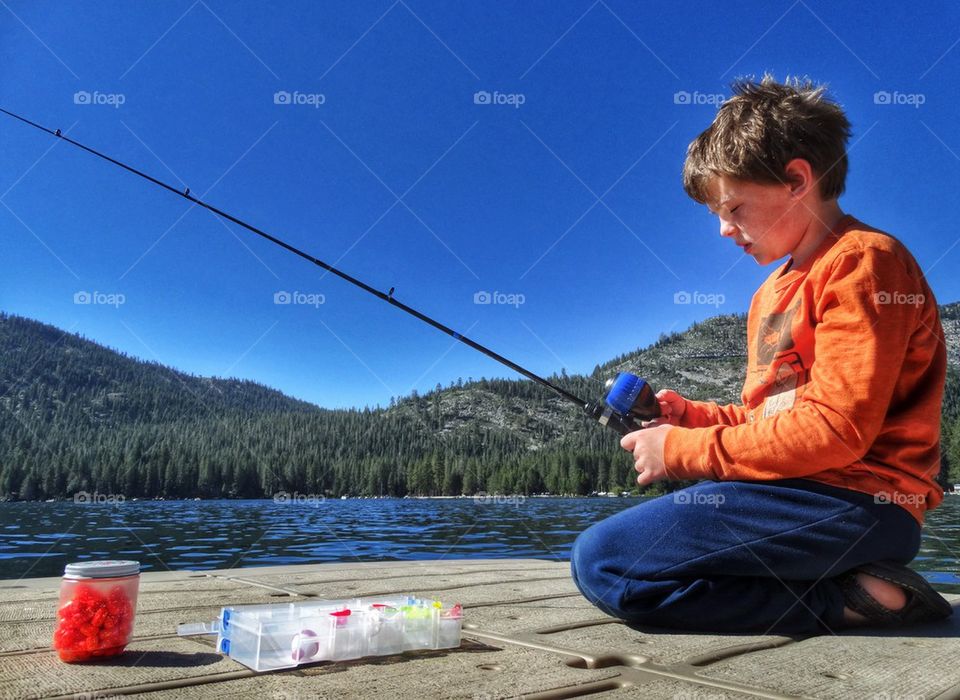 Young Boy Fishing On A Lake. Fishing In The Summertime
