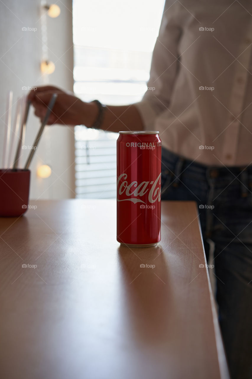 A can of Coca-Cola on the wooden table 