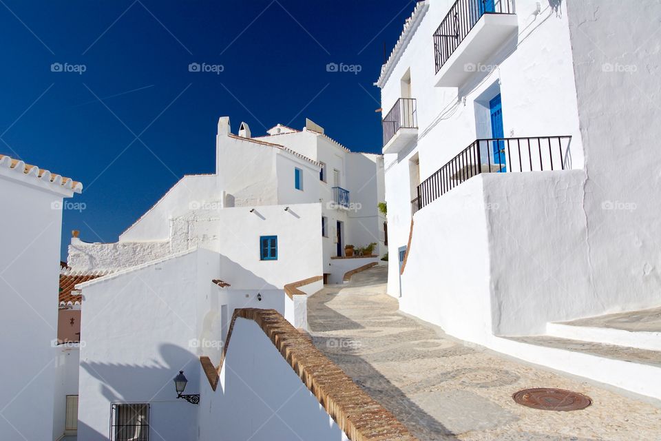 Blue and white in perfect harmony in the magical white village of Frigiliana in Spain 