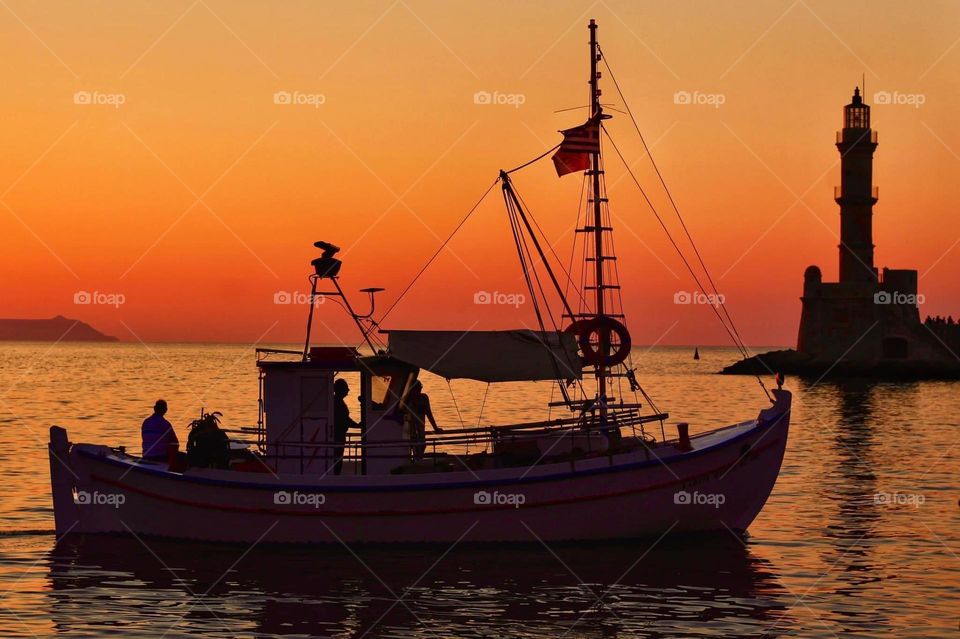 Ship against sunset i Hania Old docks, Crete
