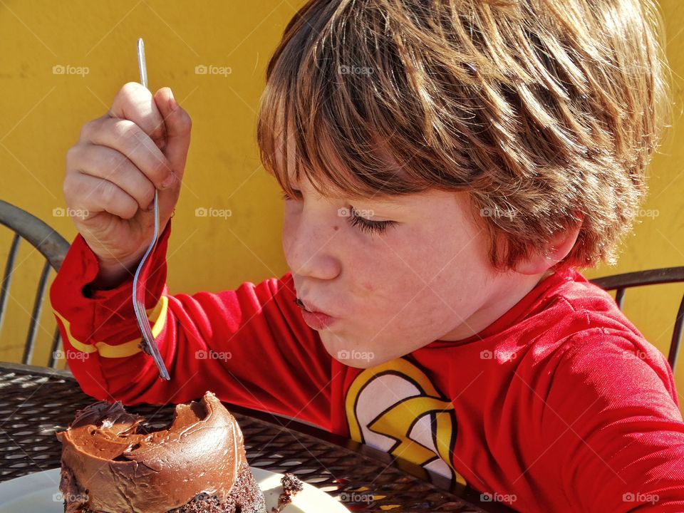Boy Eating Chocolate Cake

