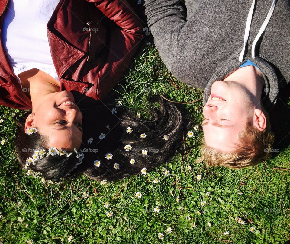 High angle view of couple lying on grass