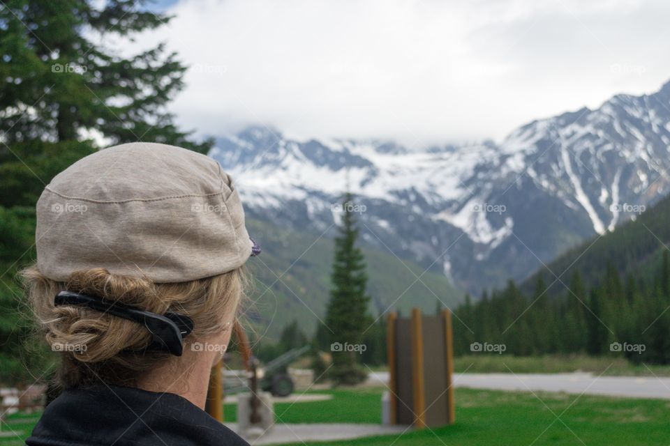 Making decisions, woman looking afar off toward the mountain pinnacles, DESTINY