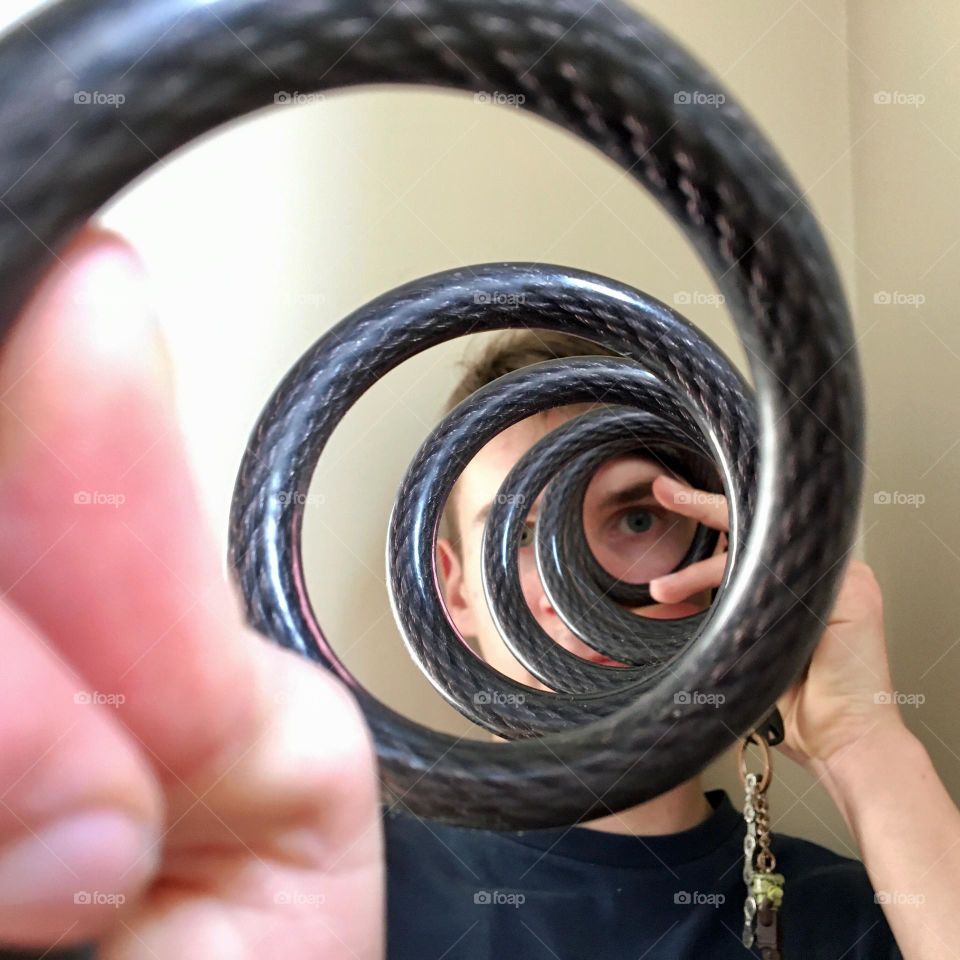 Round spiral shaped bicycle lock being stretched 