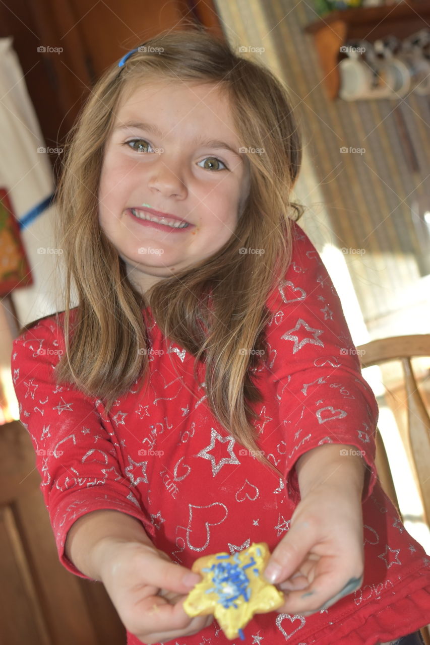 girl proud of her cookie decorating