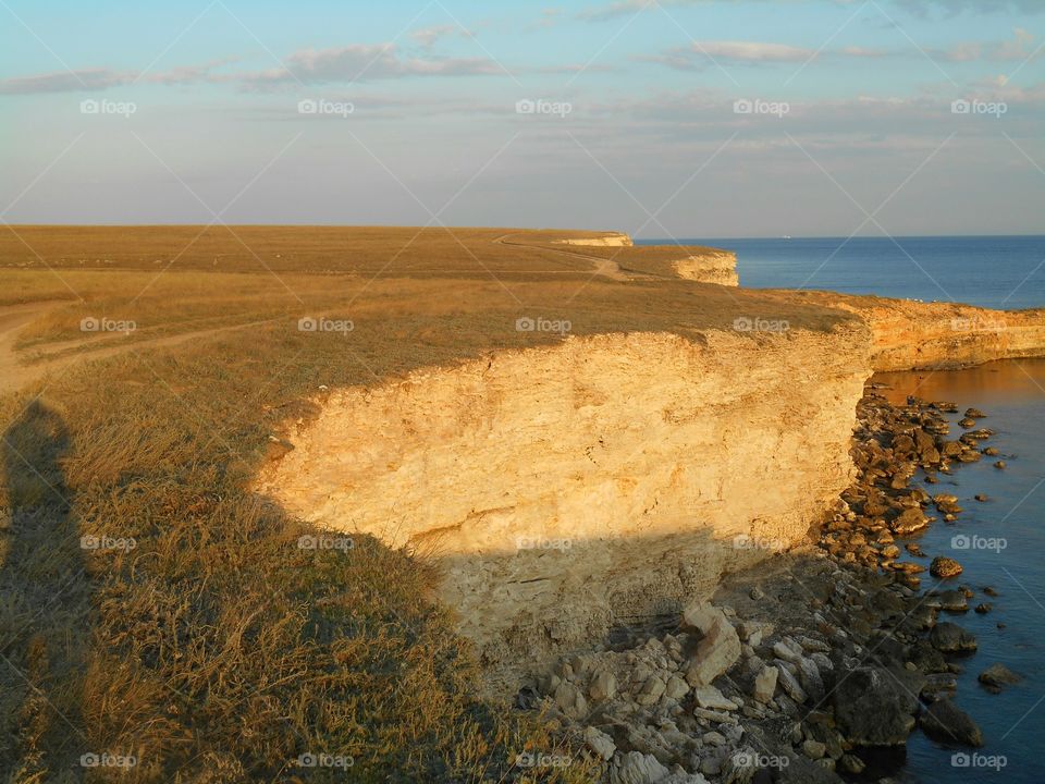 shadows people on a sunset steppe ans and sea cliff wild travel summer landscape