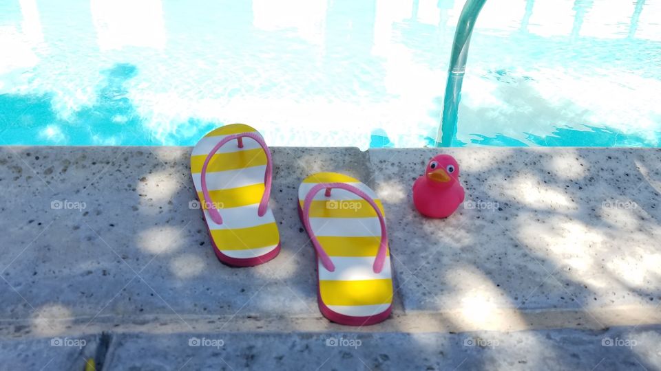 Flip flops and a pink duck