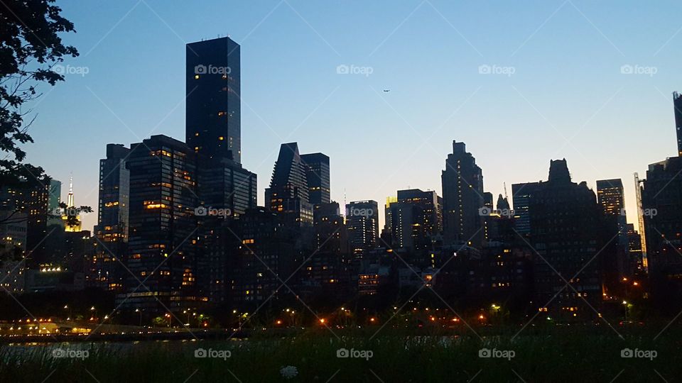 cityscape at night near downtown over East river in New York city manhattan