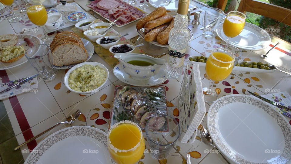 Breakfast for kings. Beautiful delicious Sunday brunch with fresh orange juice,bread and butter, mimosa and cold cuts 