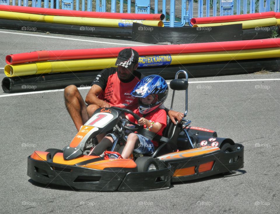 Young learner. Young kid learning to drive a go-kart