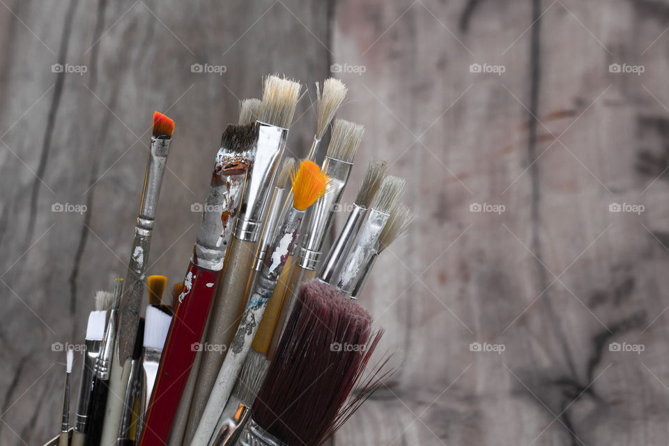 Close-up of paint brushes on wood