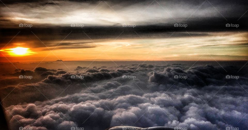 Sunset above the clouds while flying... the photo is taken above Java, Indonesia