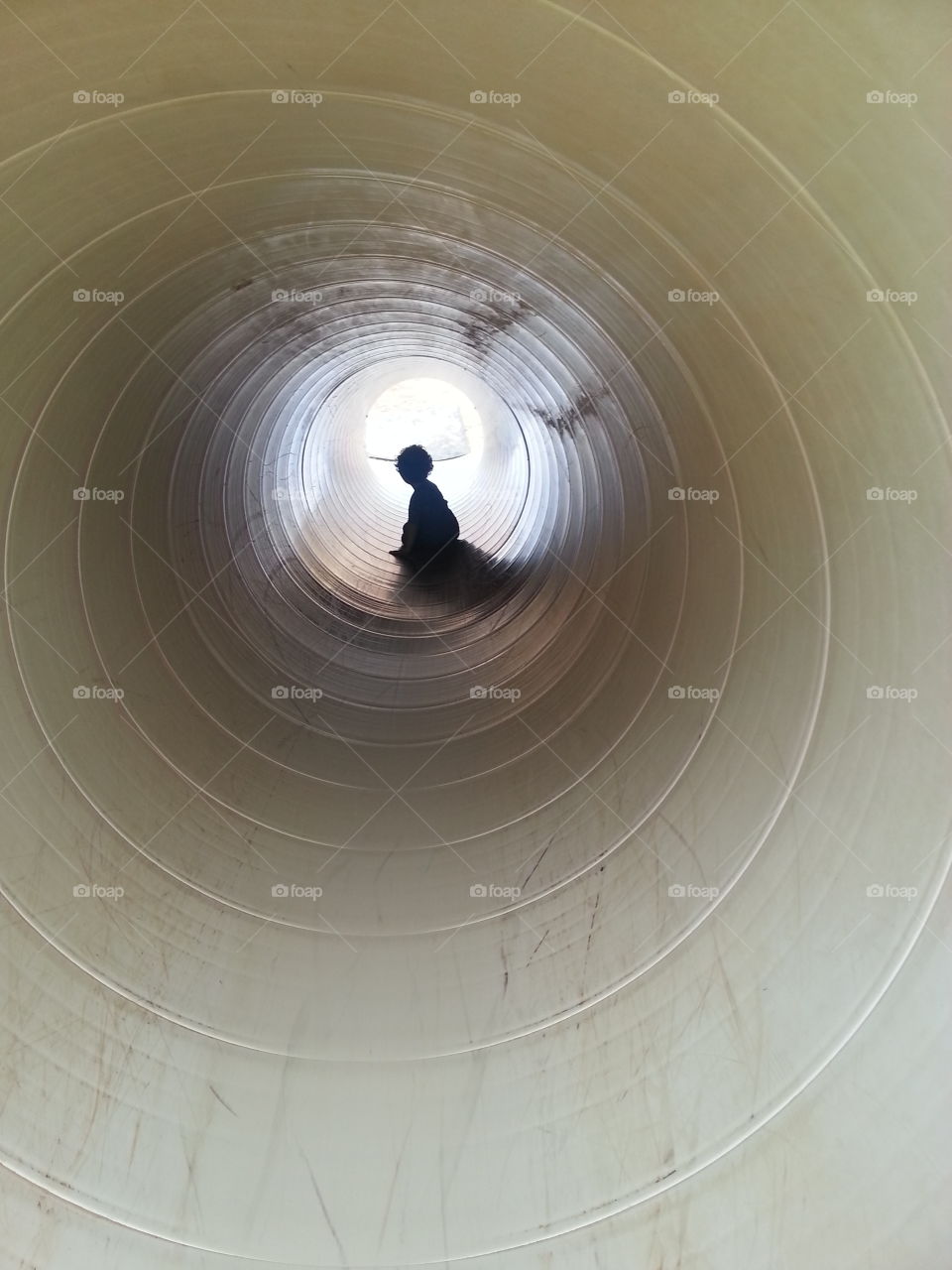 Boy Sliding Down a Tunnel.