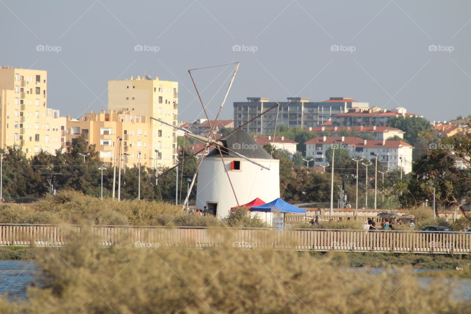 Lagoon's windmill, countryside, nature and modern city all together 