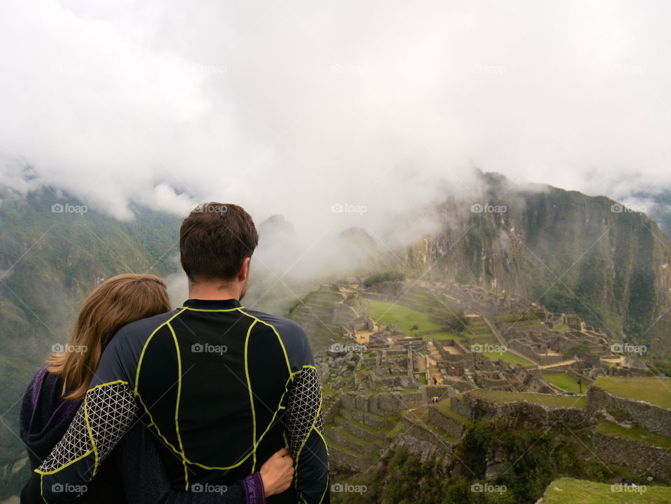 Couple enjoying the view on Machu Picchu after a long hike