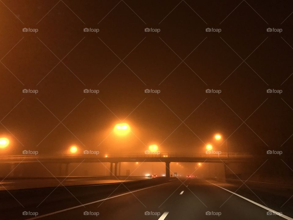 Highway fog in the mist with orange streetlights