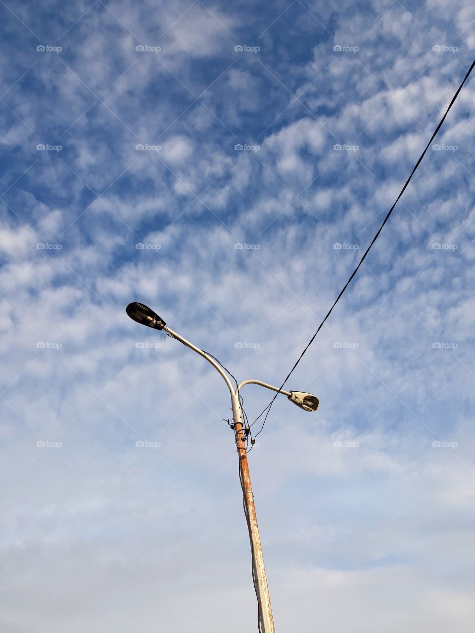 two street lamps under the blu sky