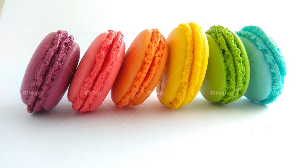 rainbow macarons on a white background