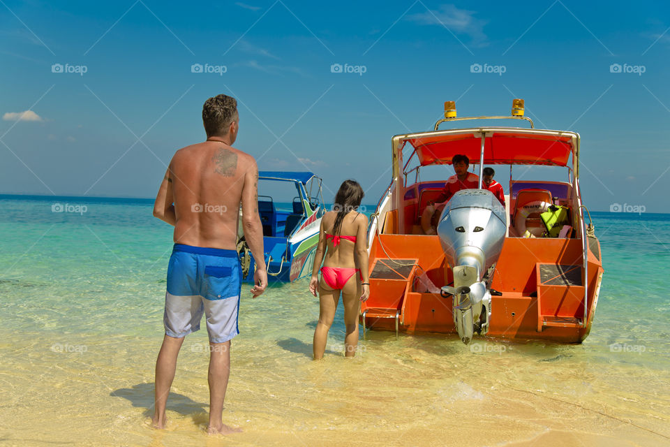 Tourist going on a speed boat . Island hoping tour on popular Thai beach