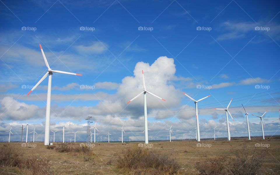 Windmills and beautiful clouds on the blue sky