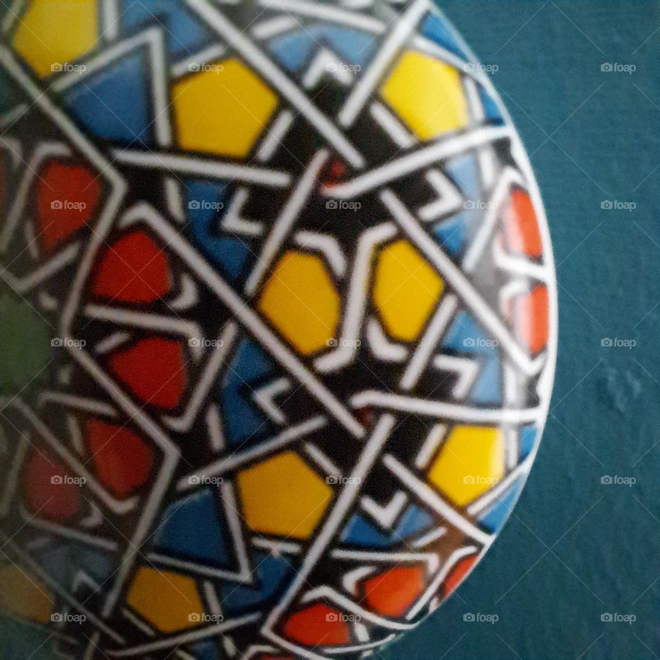 bright colours. close up of draw handle. blue yellow red. round