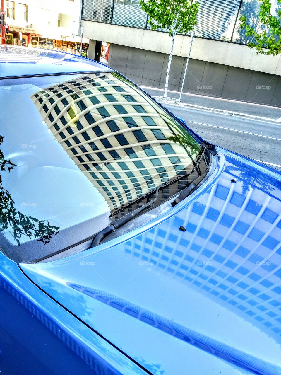 building reflection in car window