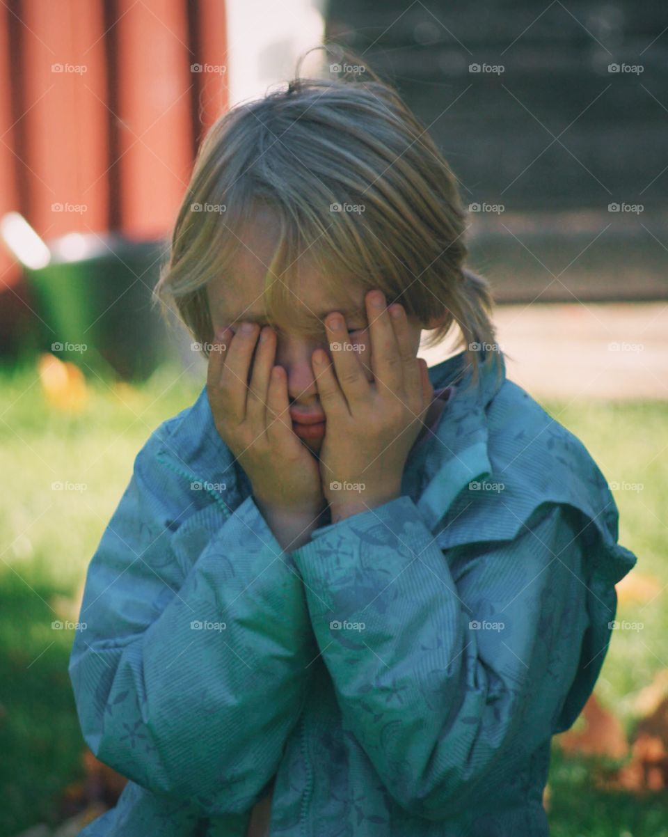 Little girl with hands on her face