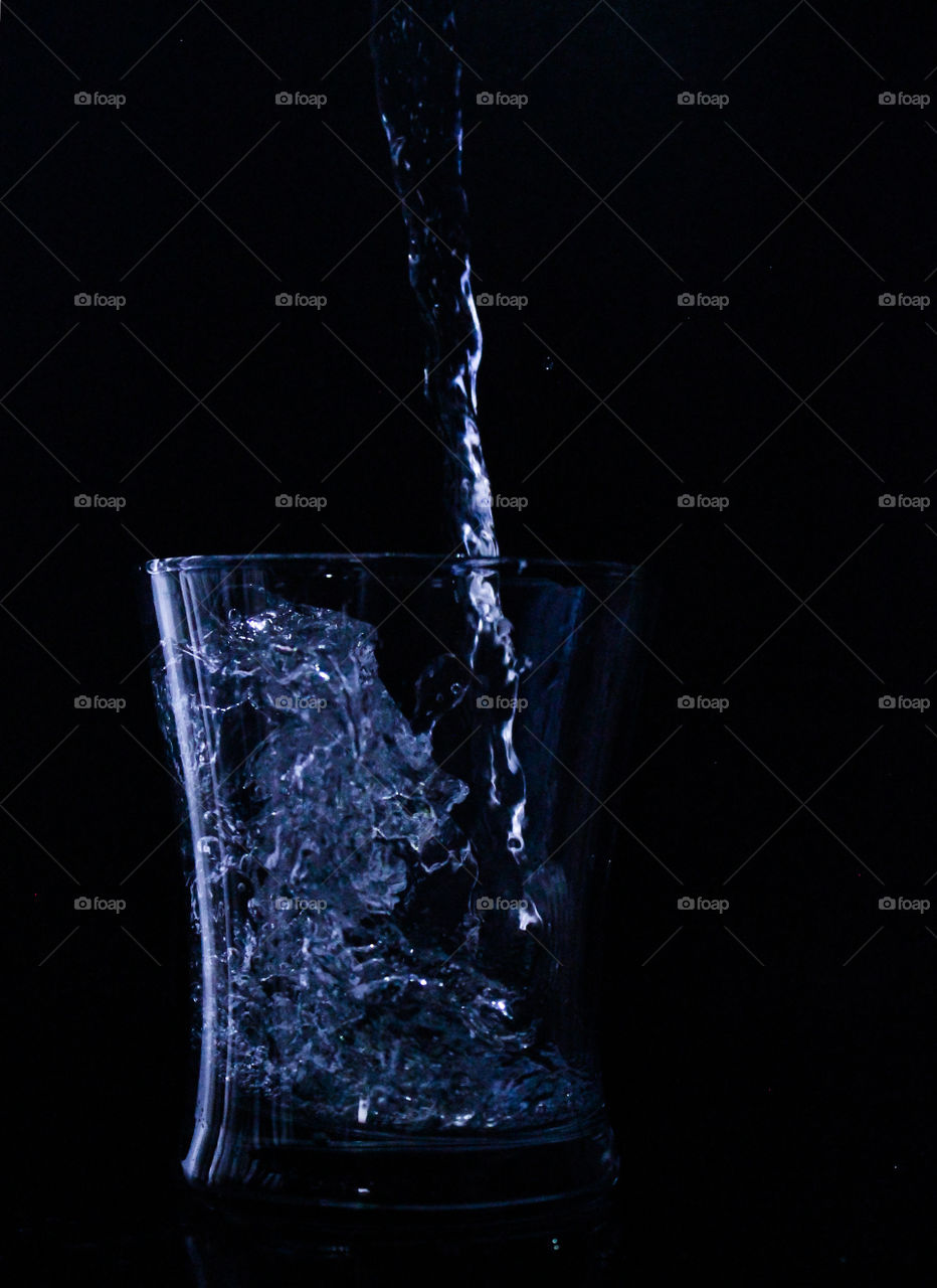 Water flowing into a cup 