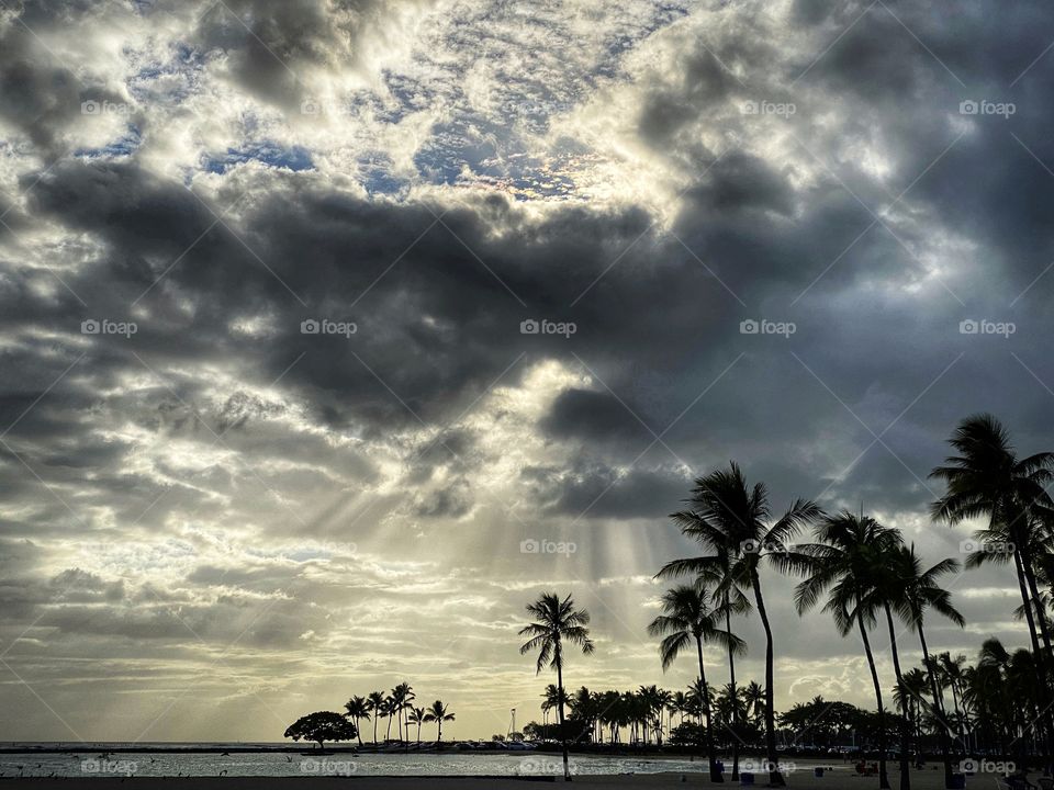 Tropical landscape with sunlight streaming through clouds
