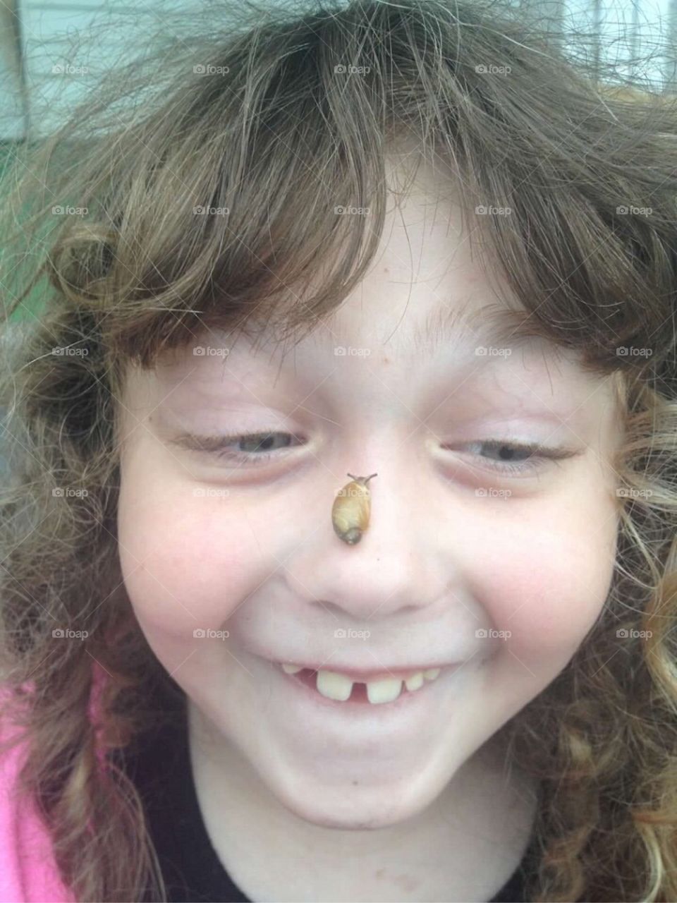 Close-up of shell on girl's nose