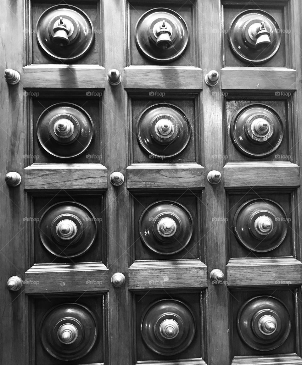 A temple door designed in a circles in between square shapes.