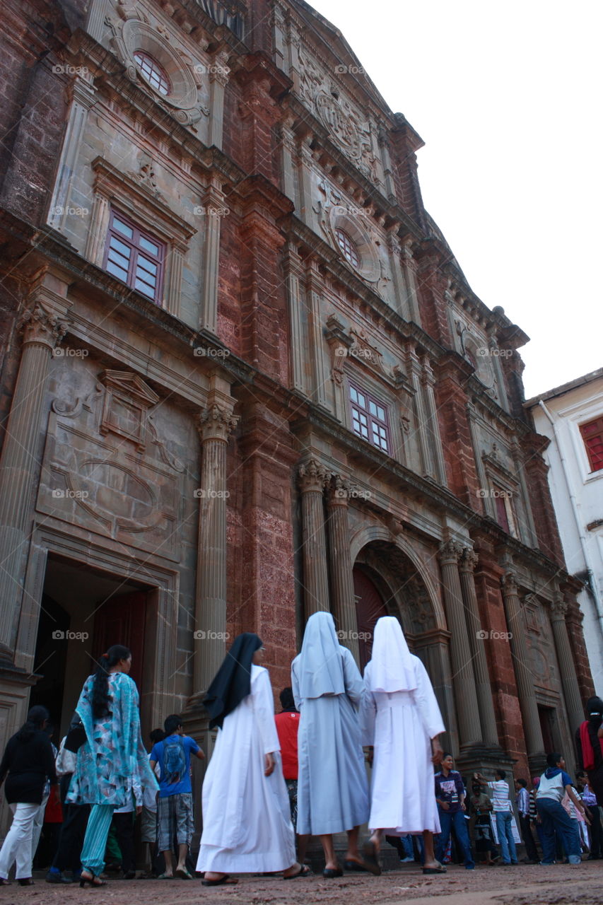 An old church and nun entering the church