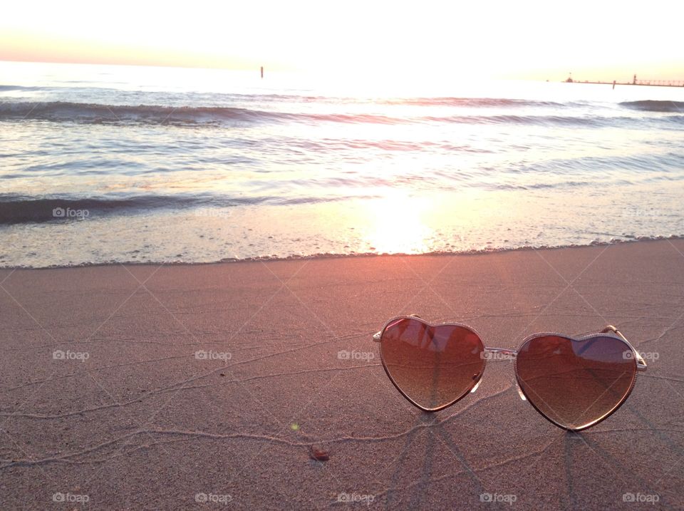 Sunglasses on the beach. I was watching a sunset in Michigan on the beach and decided to take this beautiful photo