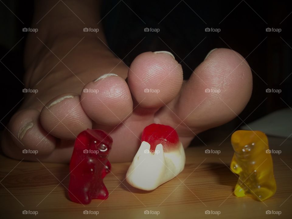 very big toes and small sweet gummy bear - the difference big and small 