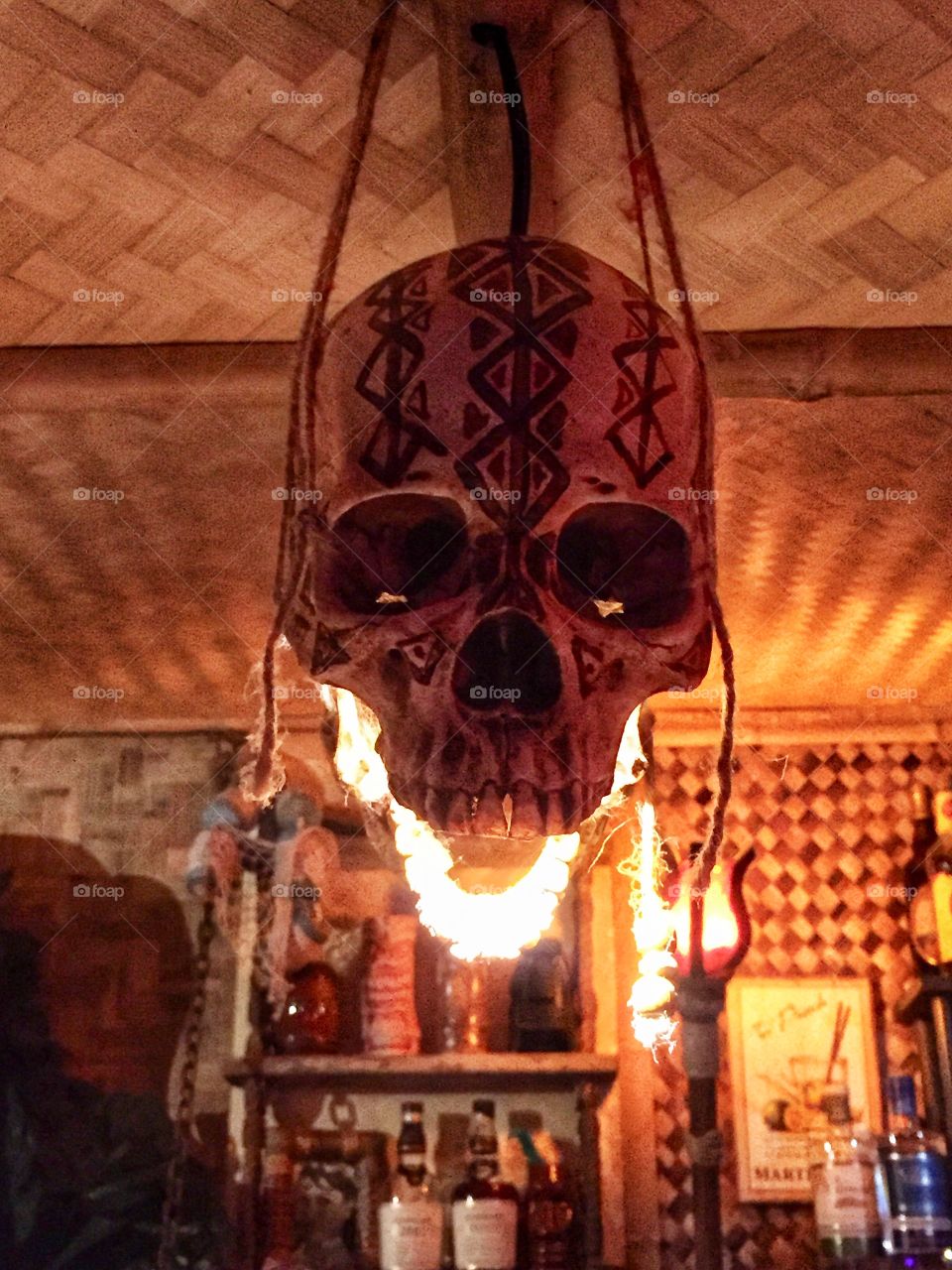 Flaming skull lantern decoration hanging over the bar in a tiki bar