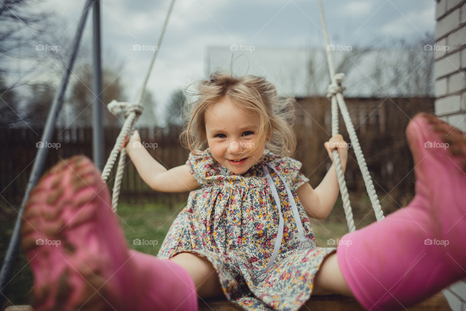 Little girl has fun on swing