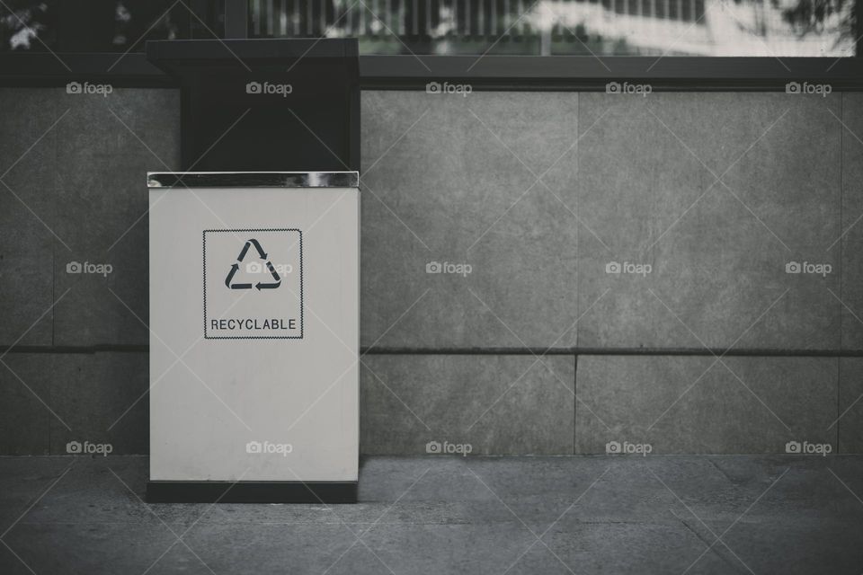 trash can against grey wall