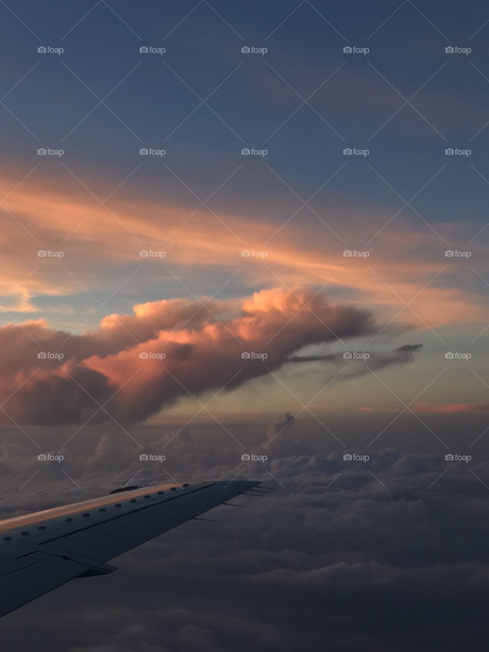Sunset from above the clouds in an airplane.