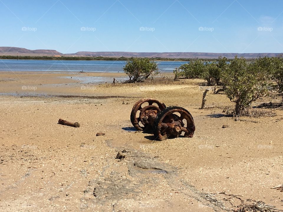 Rusted machinery washed ashore in south Australia wheel and axle