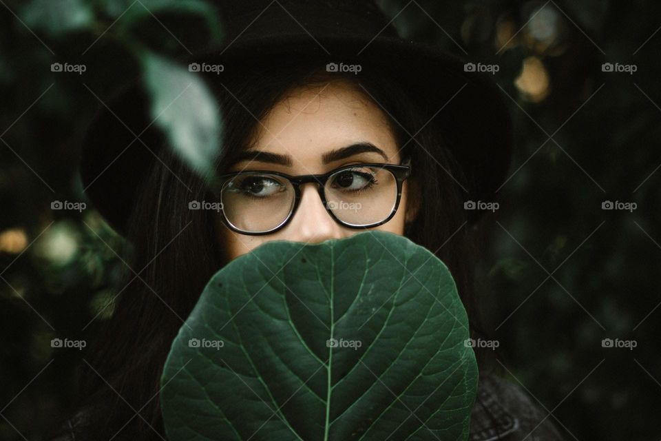 Close-up of a woman and leaf