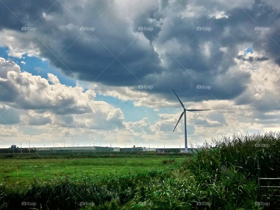 Modern windmill under a dramatic sky. Renewable energy.