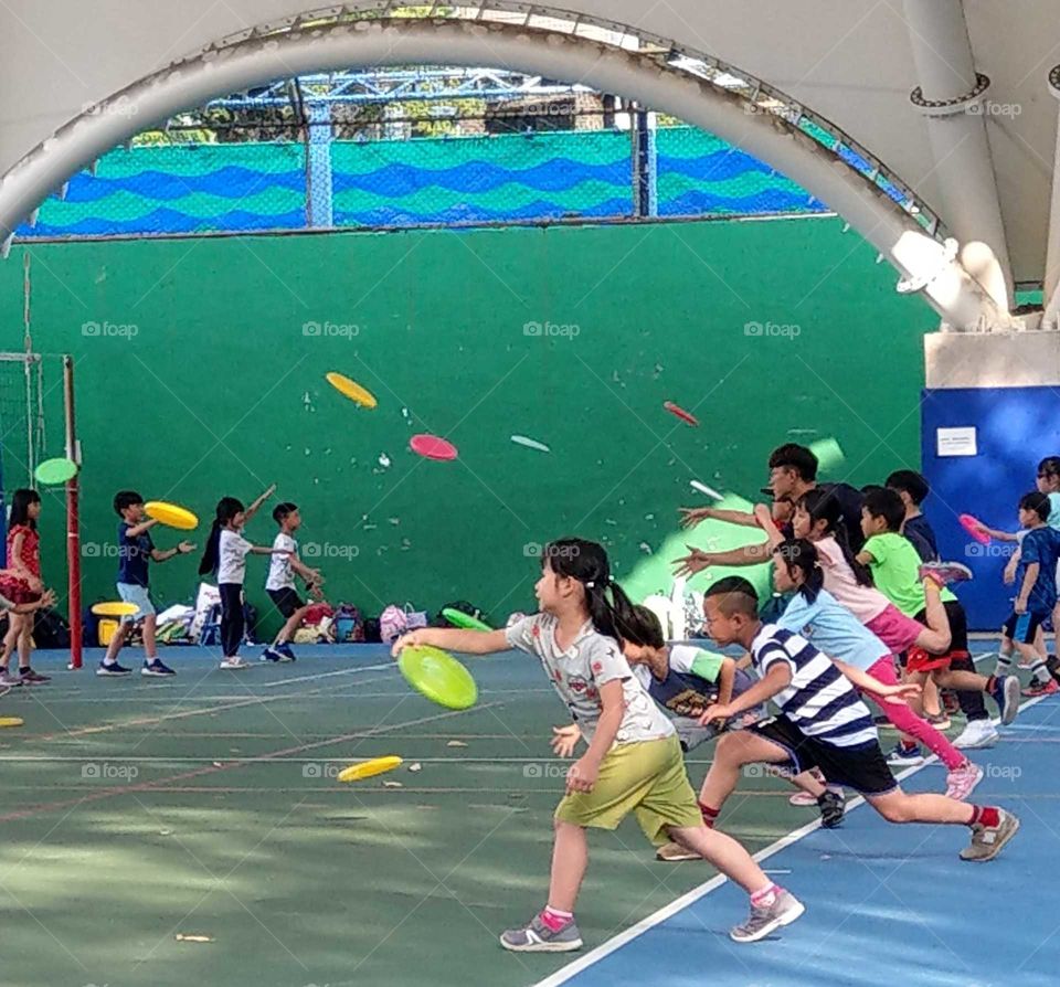 Clash of colors: children were playing frisbee exercise.