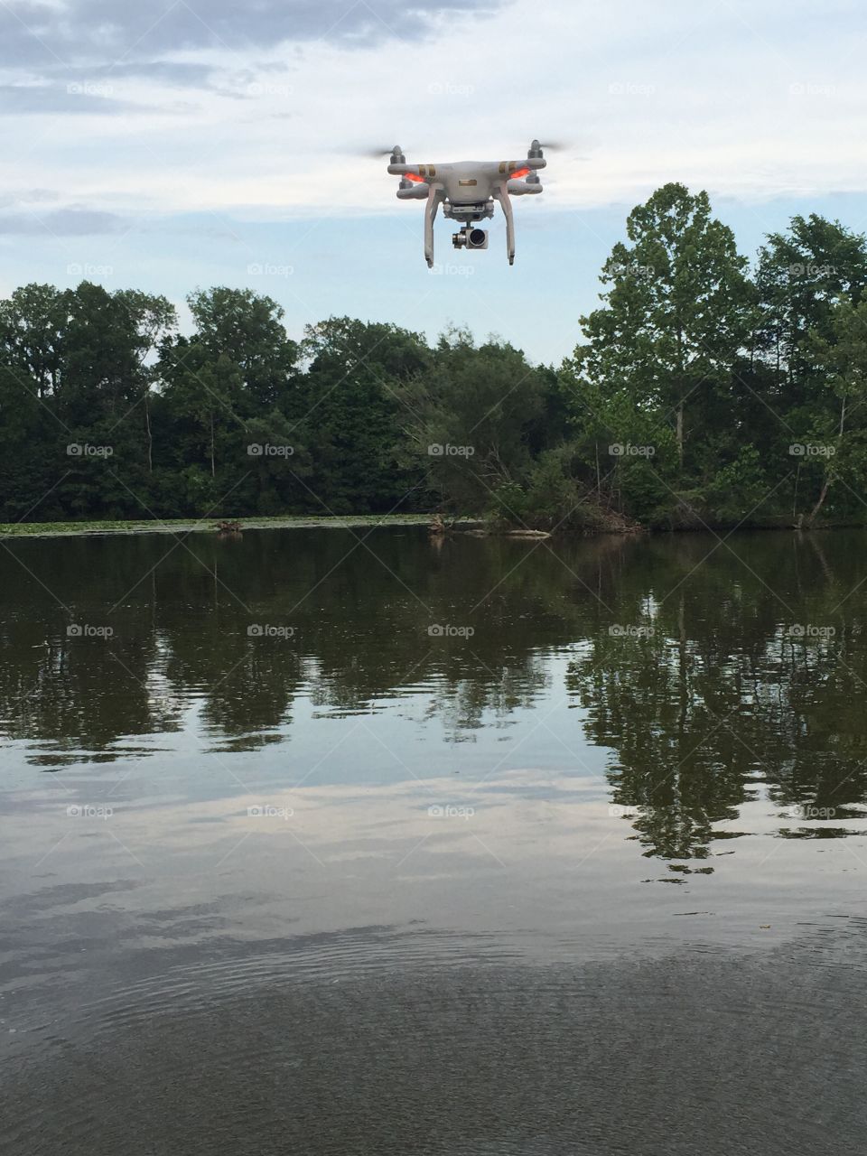 DJI phantom 3 professional . A hovering shot of a DJI phantom 3 professional over the water 