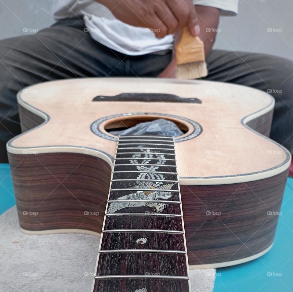 A man making hand made guitar