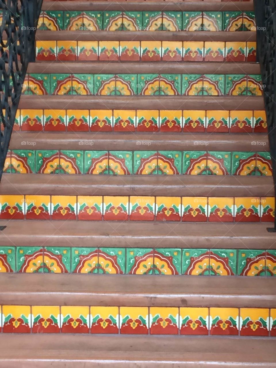 Rows of southwestern tiles behind each stair tread