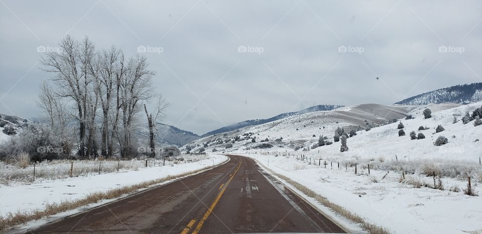 red roads of icy montana in december, about 20, 30 minutes out of missoula headed to glasgow
