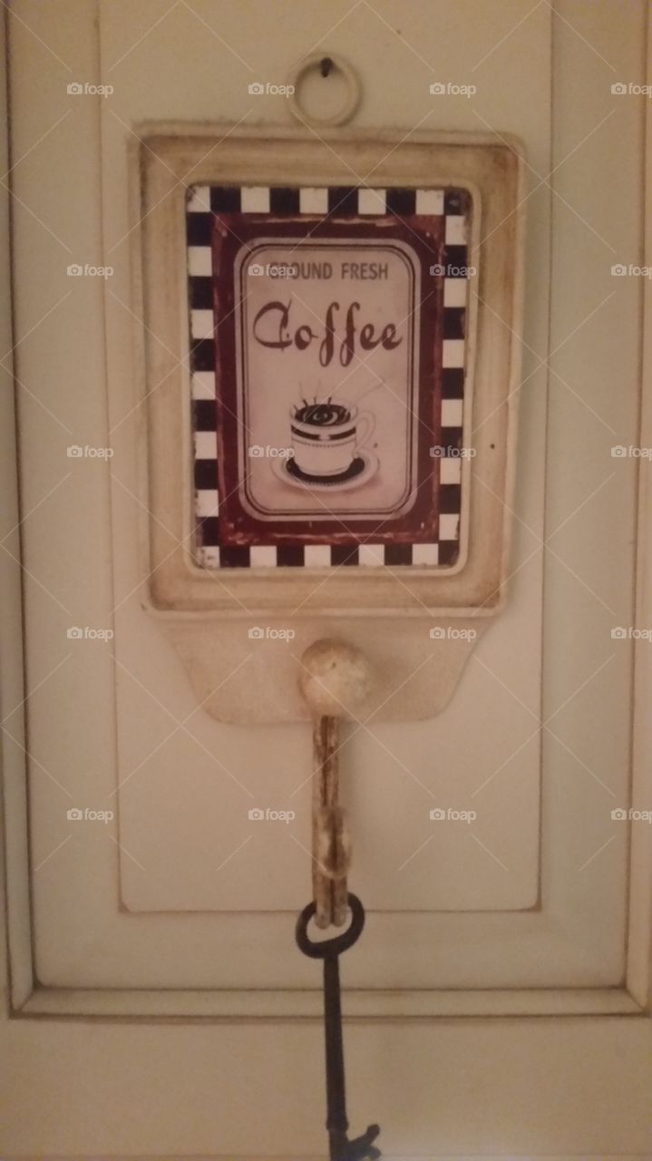 Key hook sign that says 'Fresh Ground Coffee.'