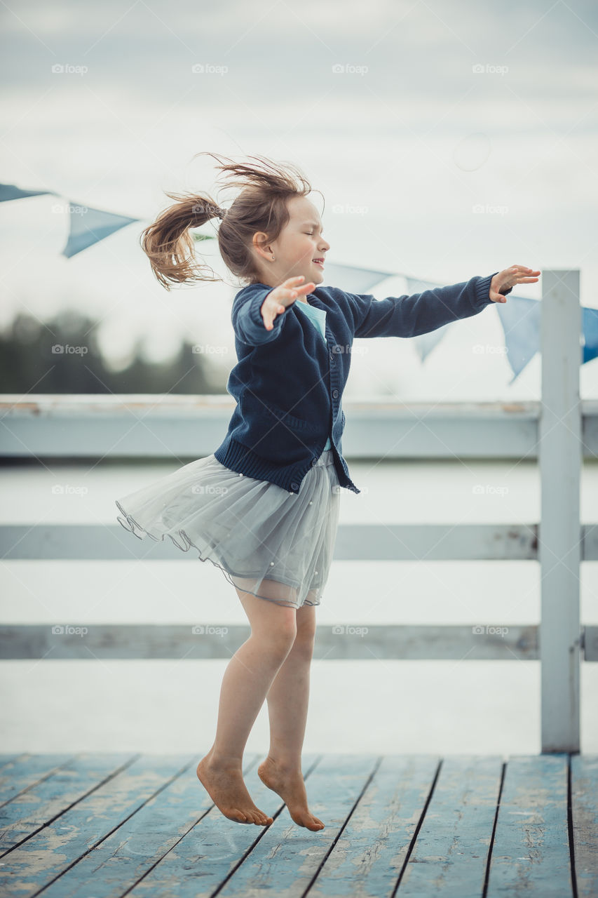 Little girl on lake coast