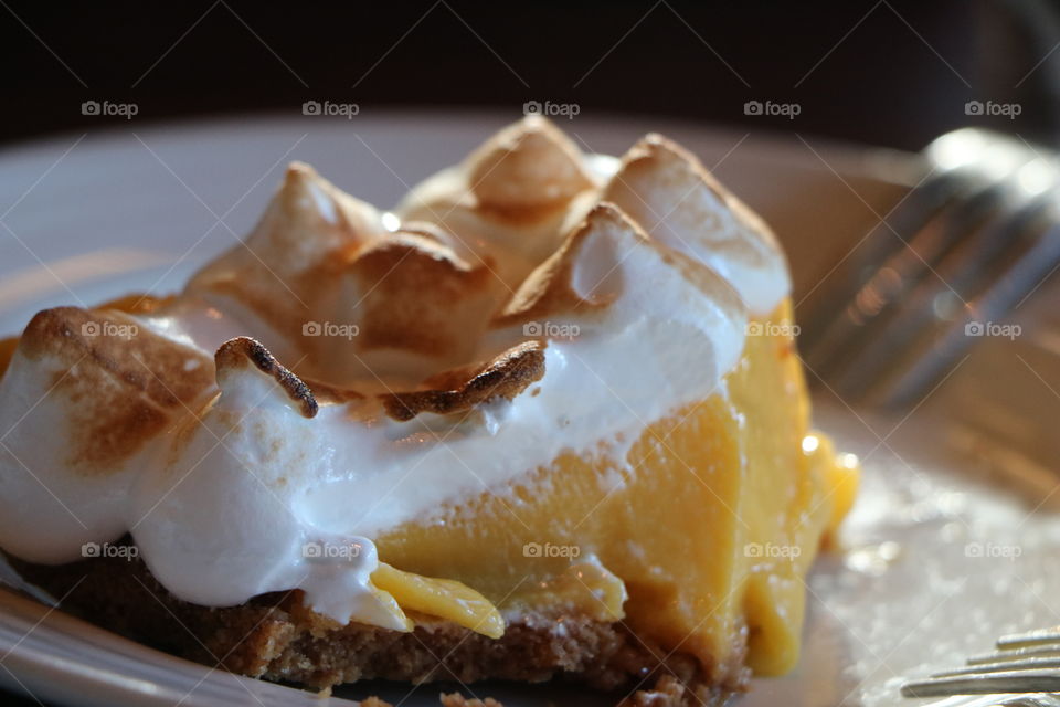 Meringue lemon pie on a plate waiting to be finished